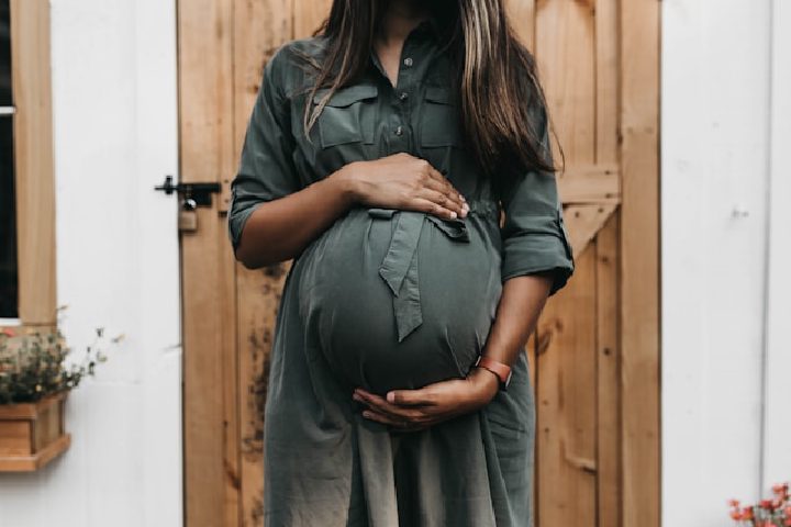 A pregnant woman holding her belly